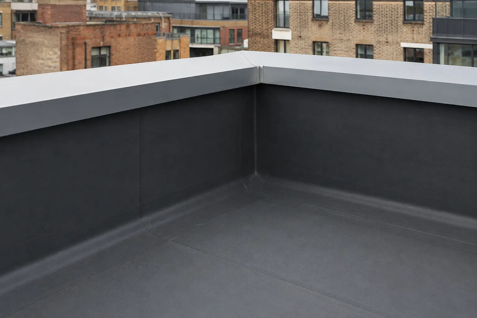 A flat-roof membrane dressed up a parapet upstand on a Dublin roof
