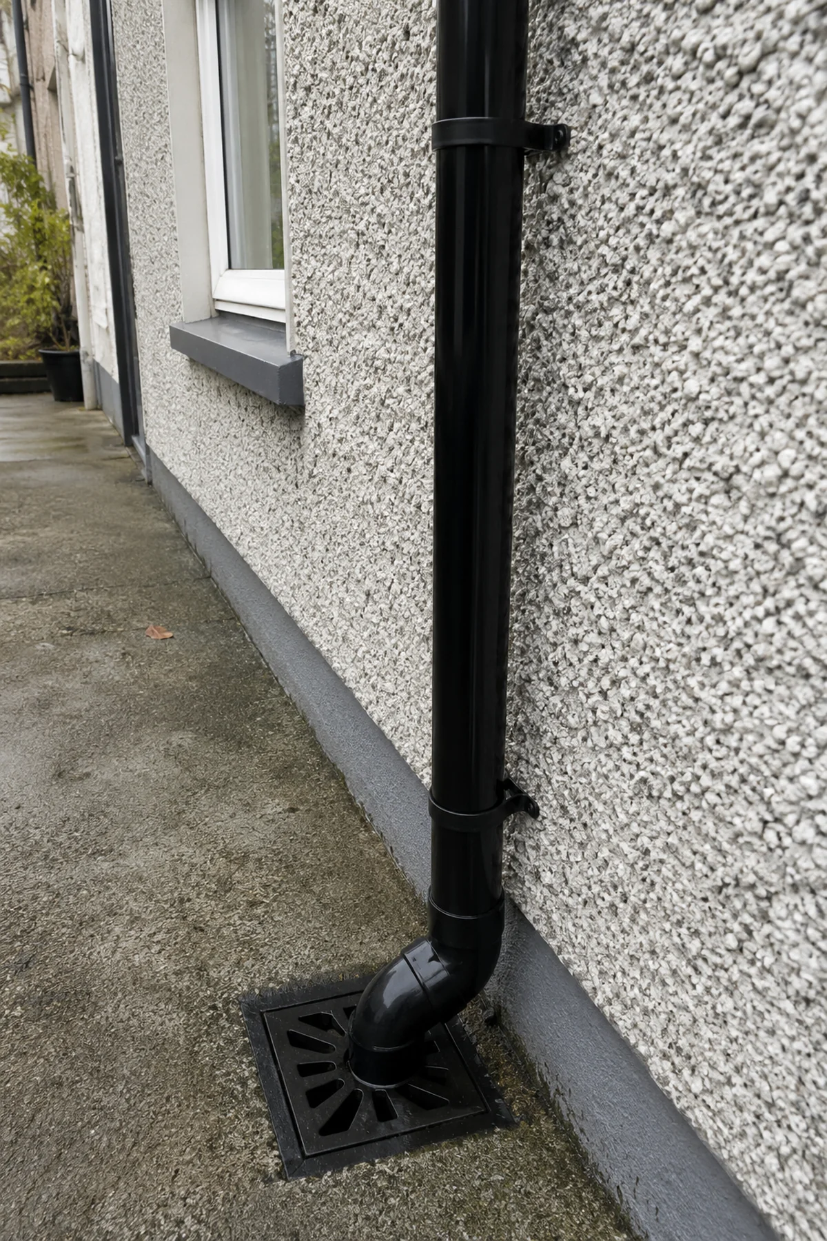 A new uPVC downpipe running to a gully on a Dublin home
