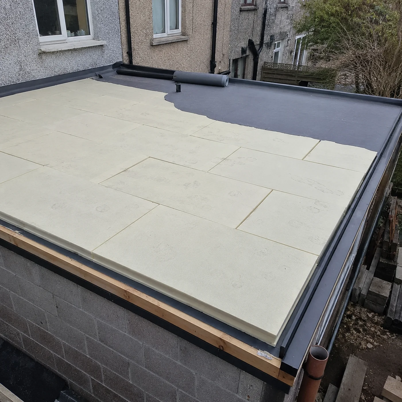 Insulation boards laid on a flat roof deck before the new covering