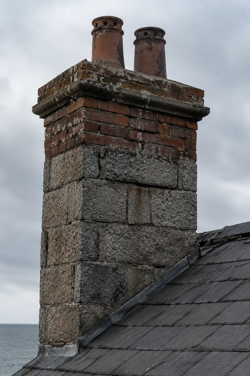 A granite and brick chimney stack weathered by sea air in Dún Laoghaire