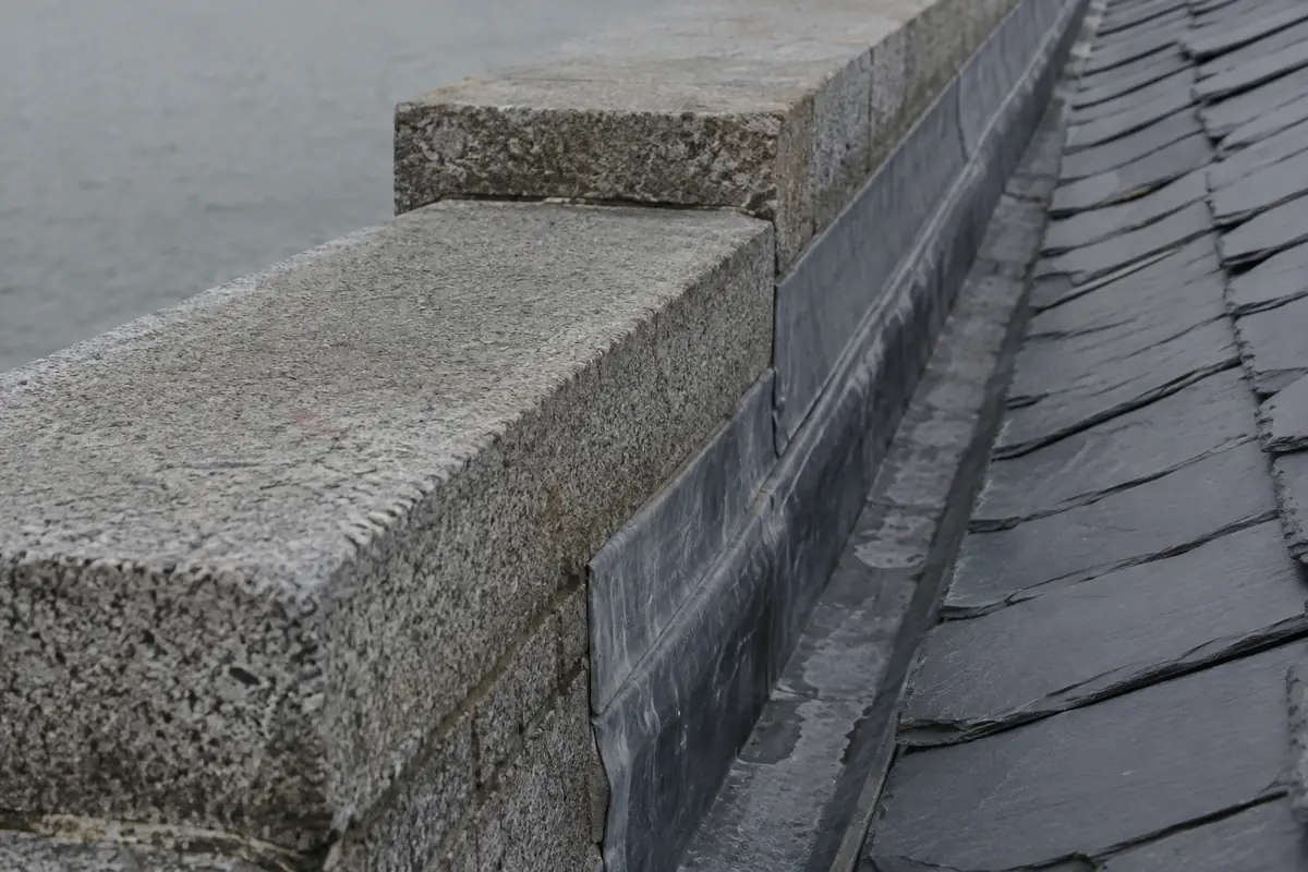 A lead-lined gutter behind a cut-granite parapet on a Dún Laoghaire roof
