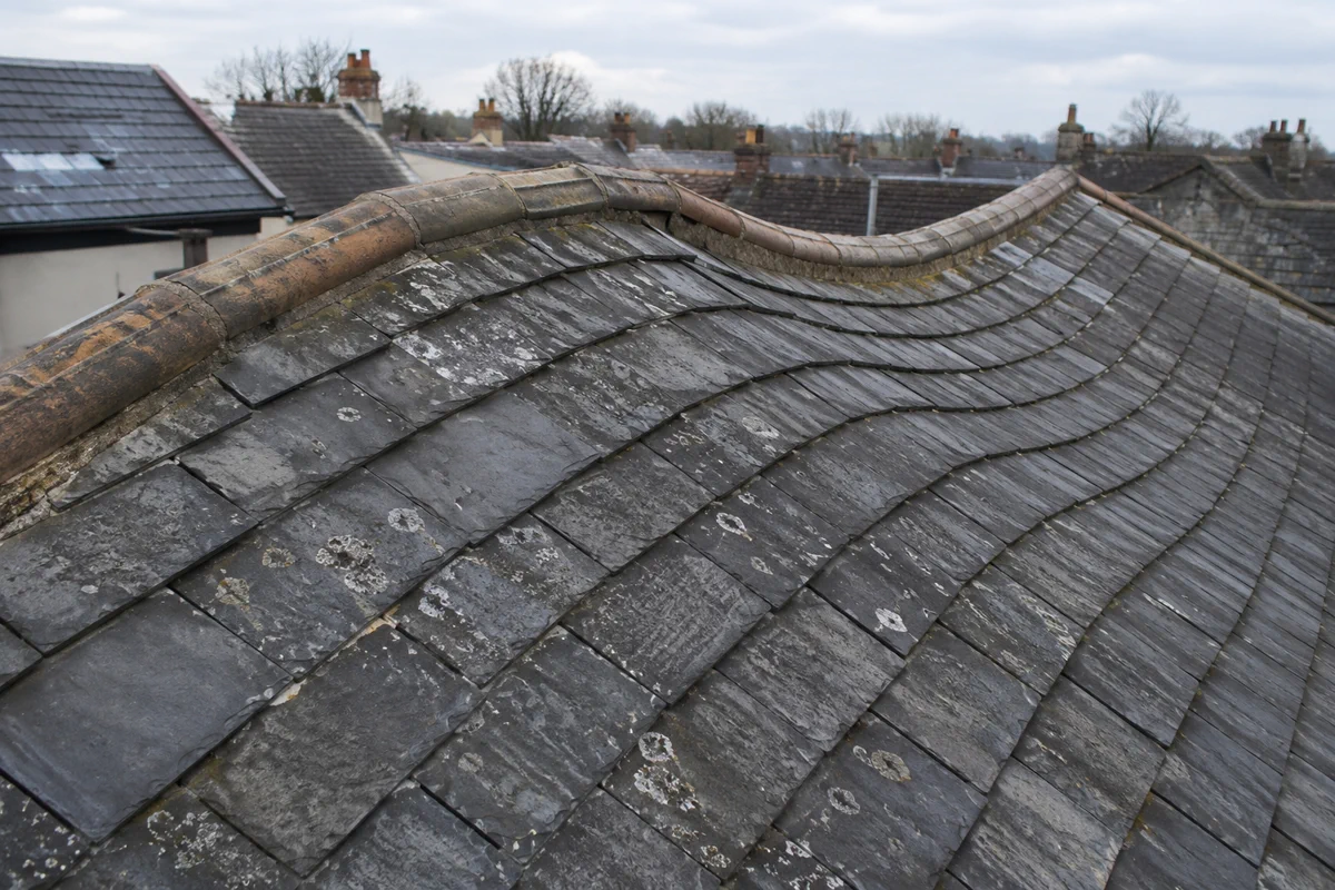 A visible dip along the ridge line of a period slate roof in Dublin