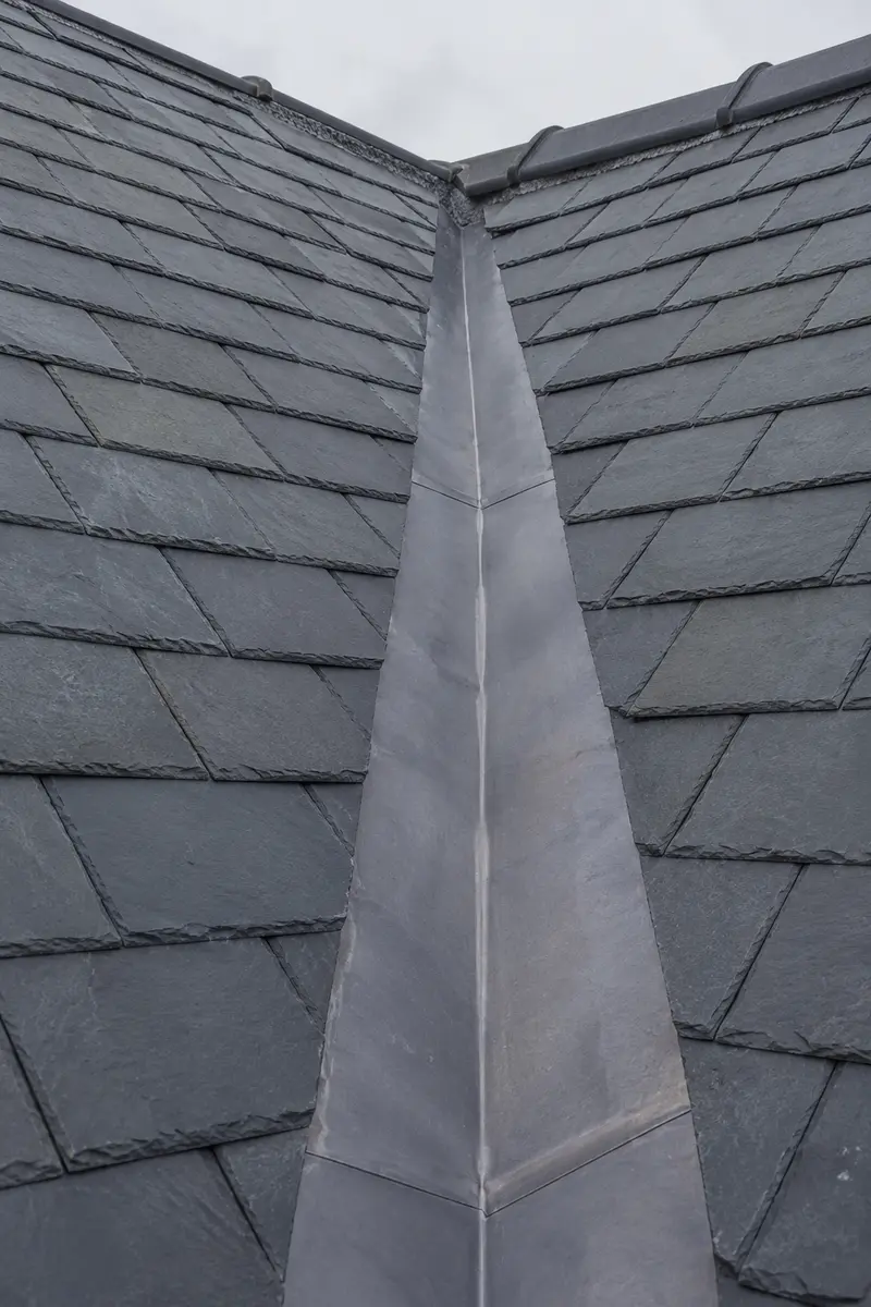 A crisp new lead valley dressed between two slate slopes on a Dublin period roof