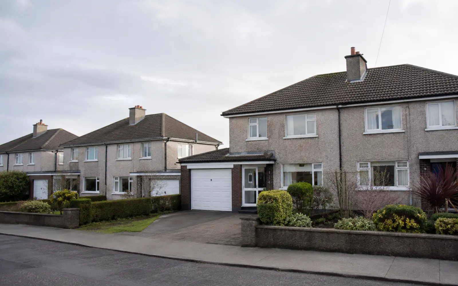 1950s and 1960s semis with integral garages and concrete tile roofs in Beaumont, Dublin