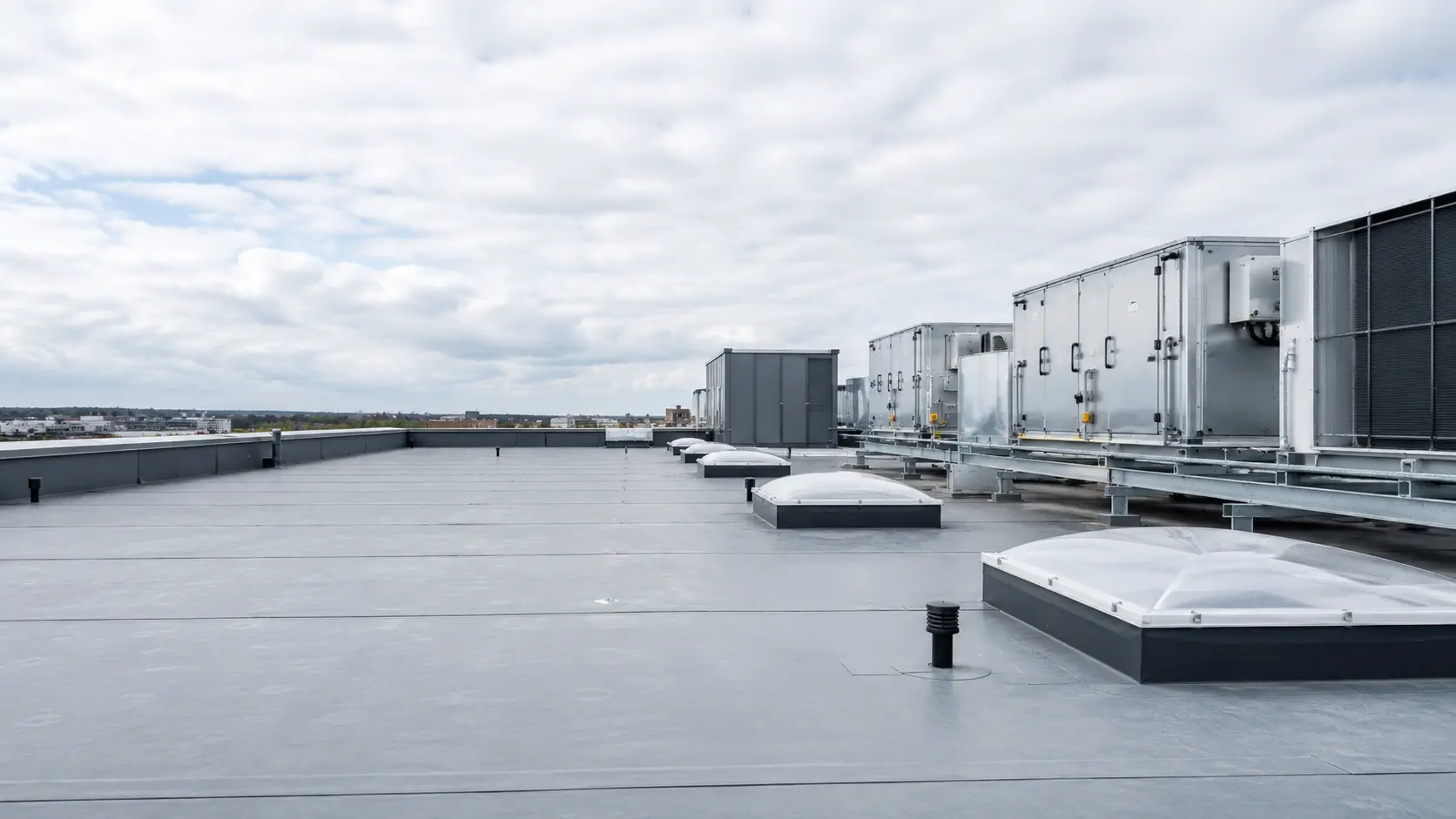 A large commercial flat roof with plant and rooflights in Dublin