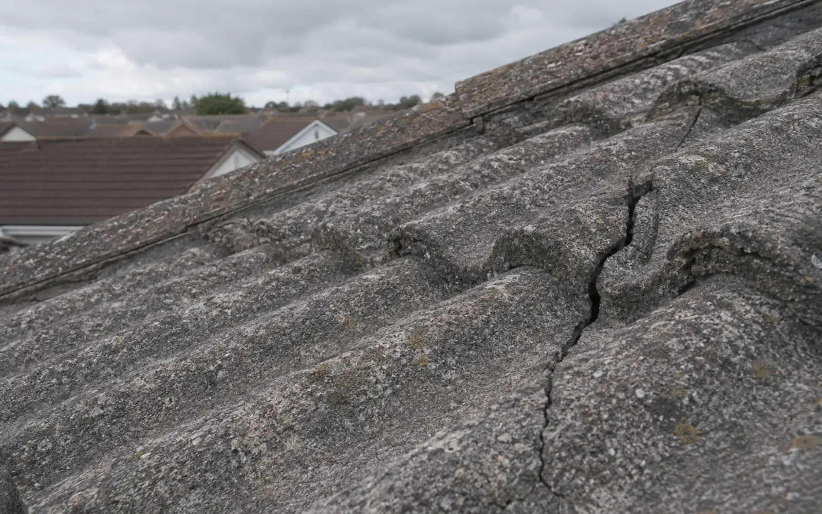 A worn concrete roof tile with its surface breaking down on a Dublin home