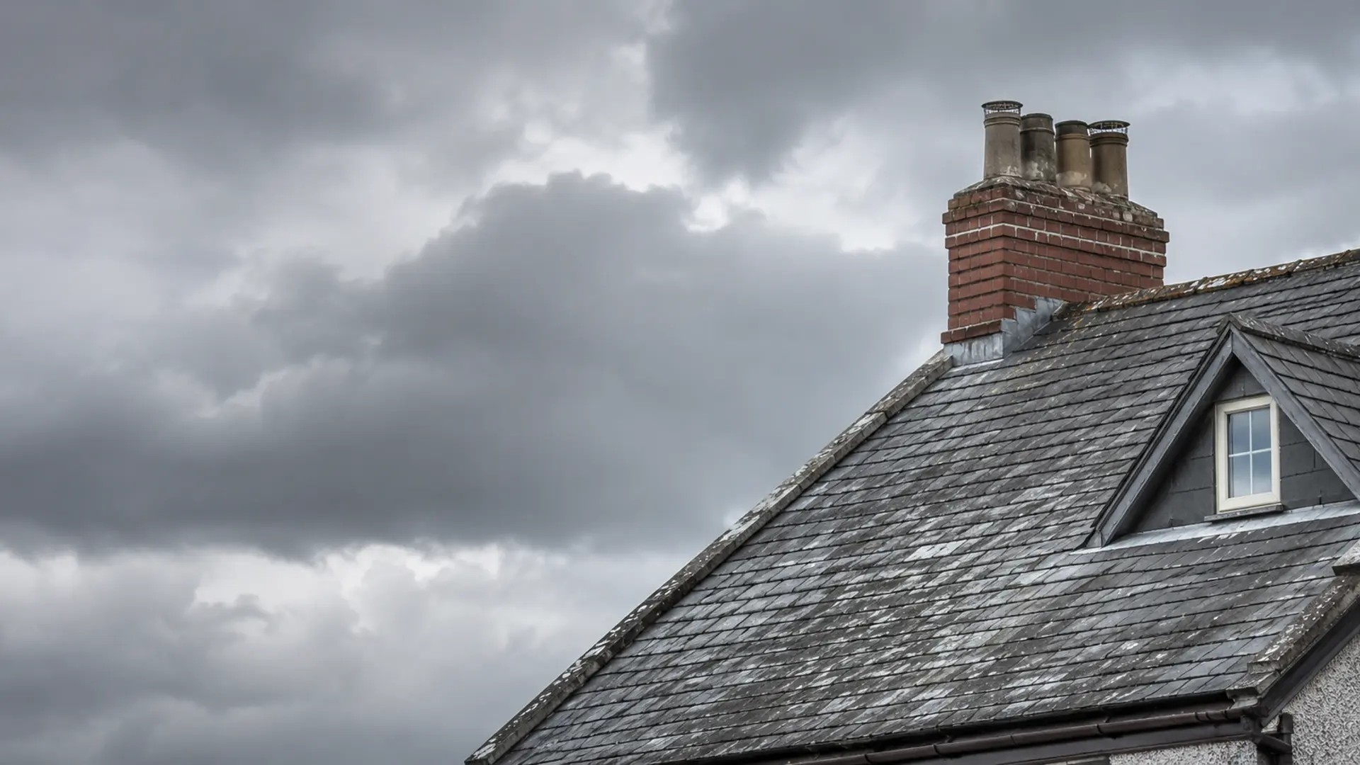 Wind lifting slates on an exposed Dublin roof during a storm
