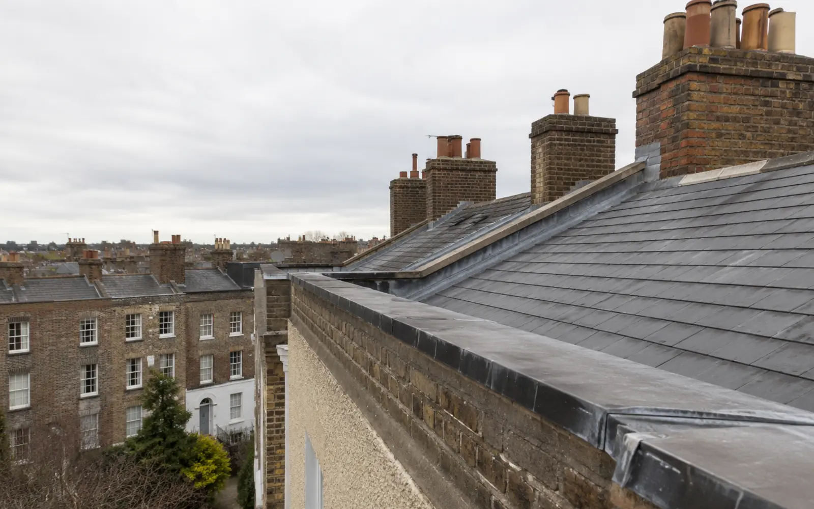 A lead parapet and slate roof on a four-storey Georgian terrace in Dublin