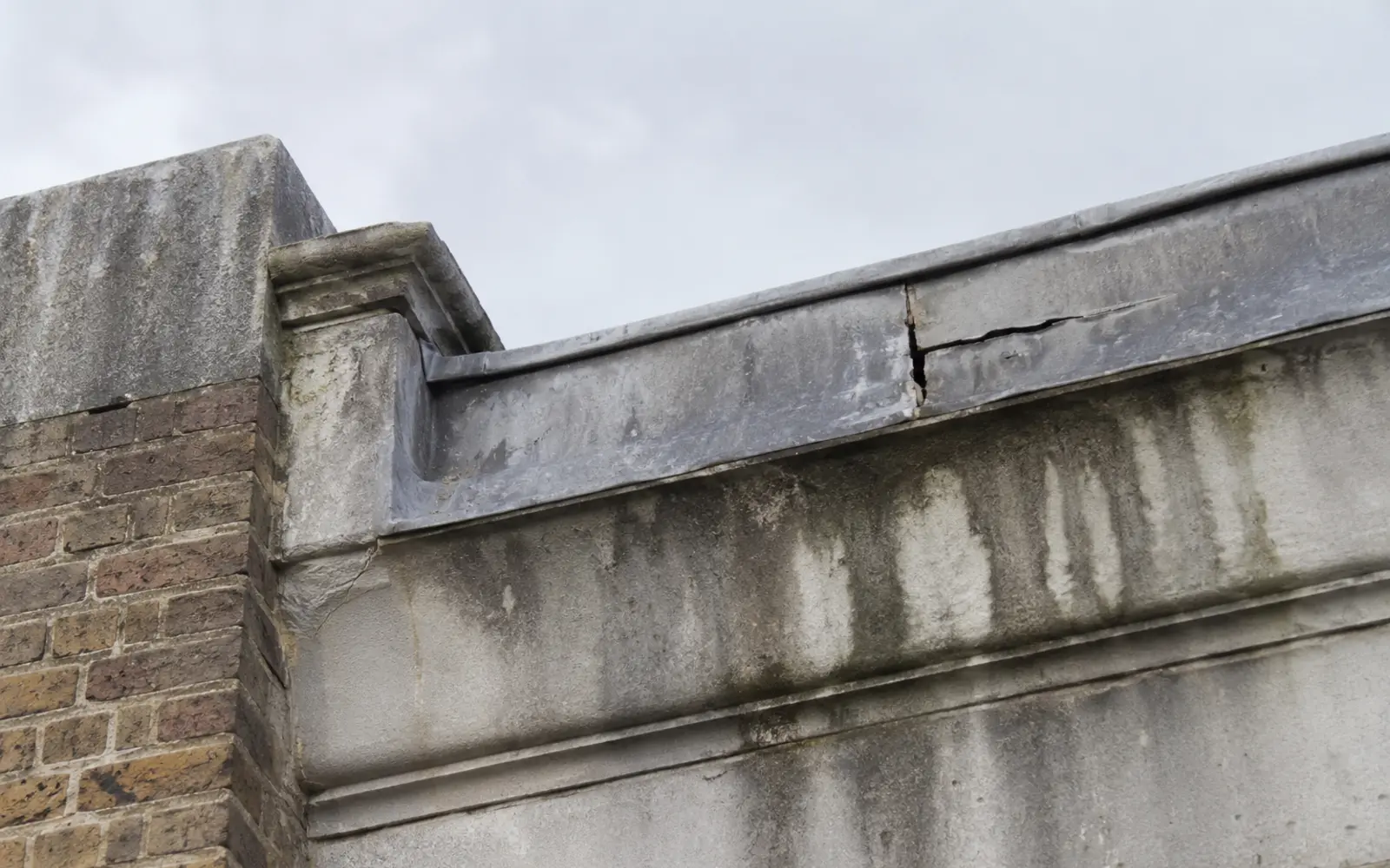 A leaking parapet gutter with perished lead on a Dublin period roof