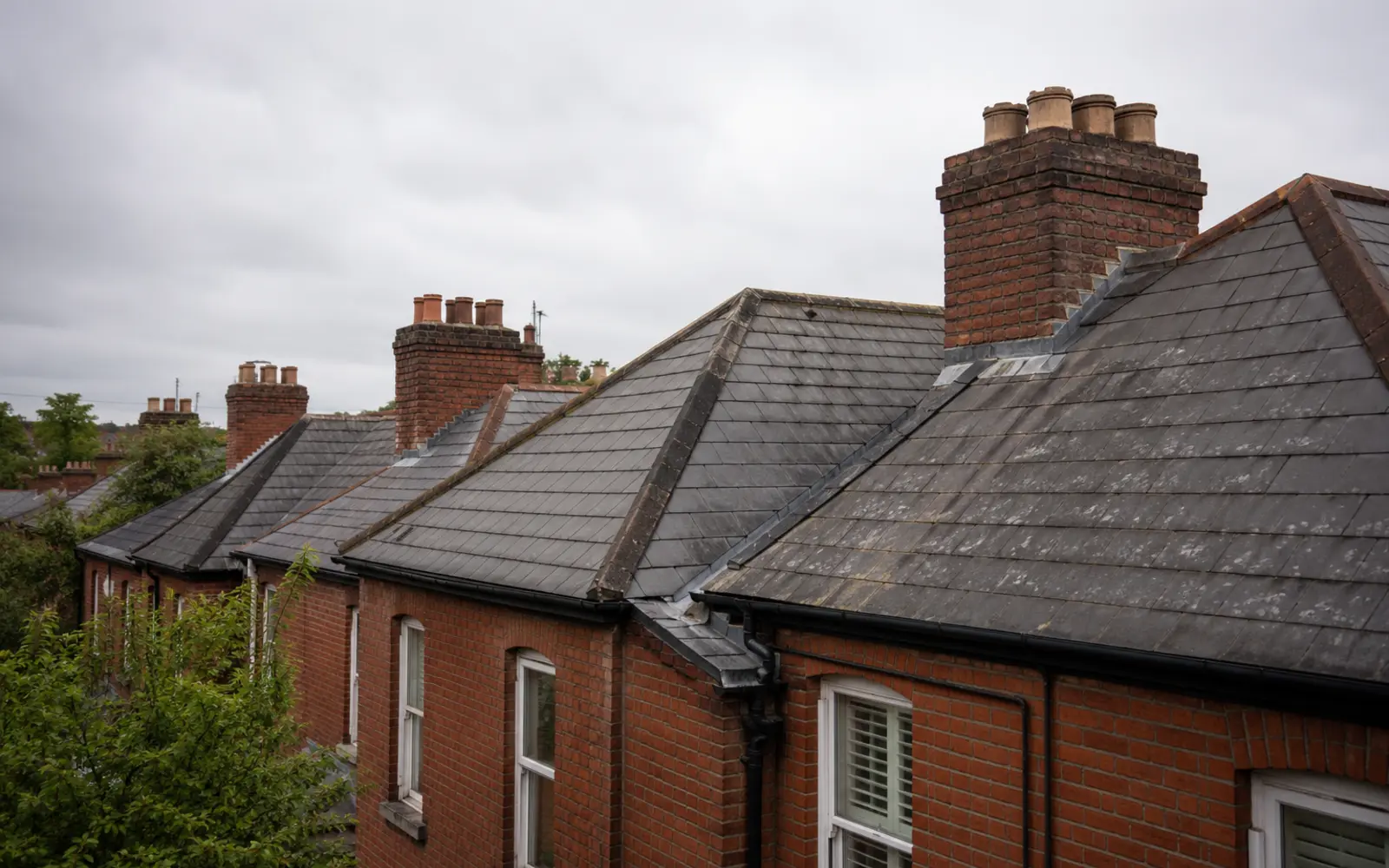 A run of Victorian red-brick terrace roofs in natural slate in Dublin