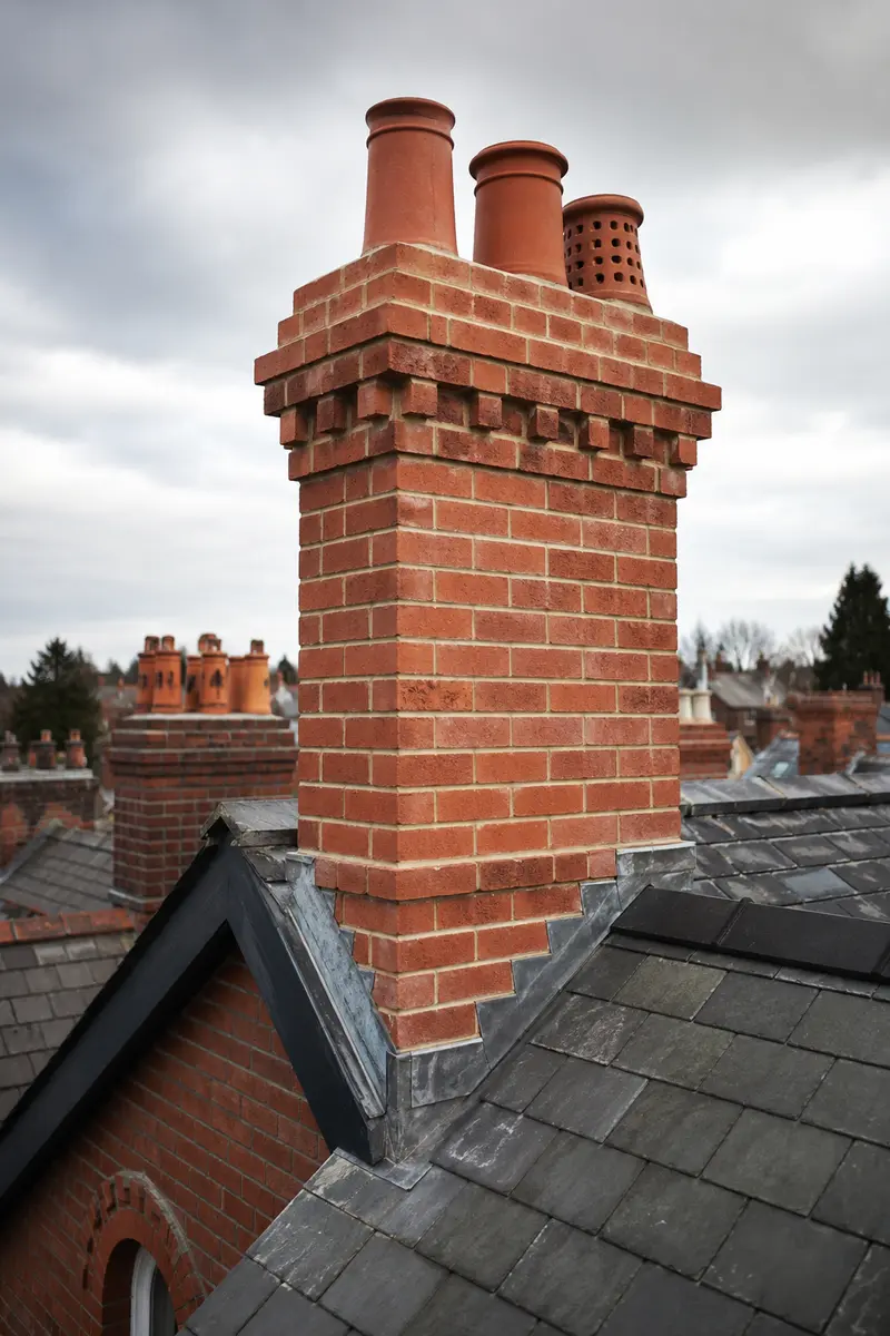 A massive Georgian brick chimney stack being repointed in lime mortar in Dublin