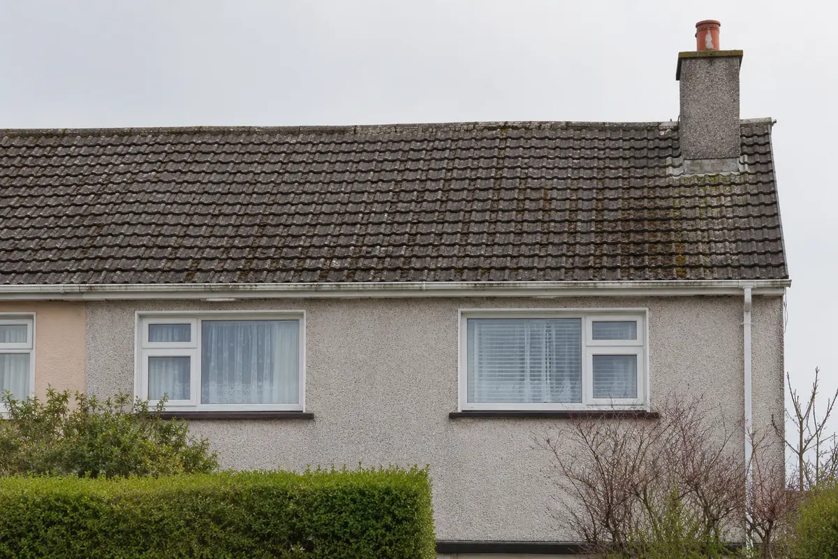 A tired mid-century Dublin roof with worn patchy tile before replacement