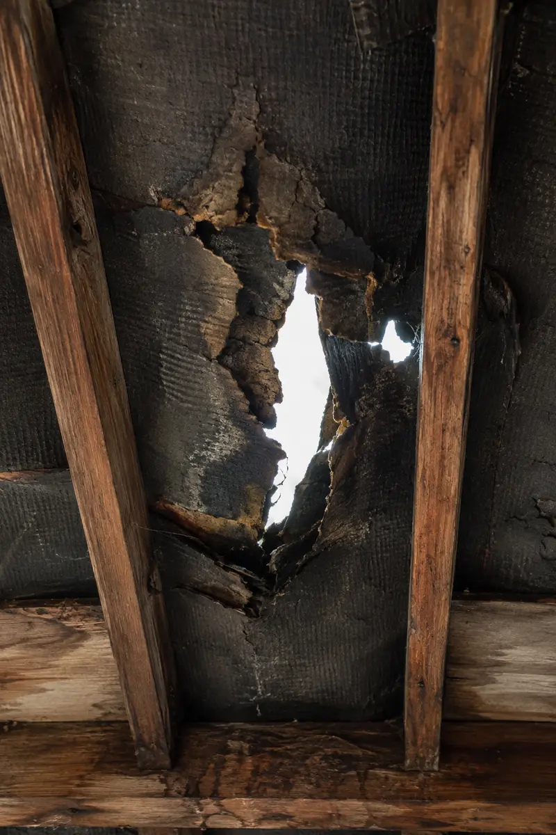 Brittle torn bitumen felt beneath the tiles in a Dublin roof space
