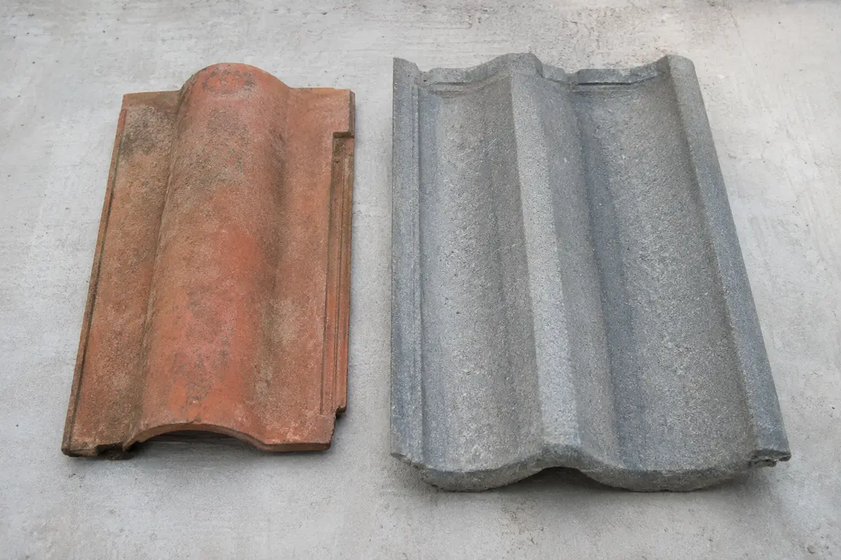 Warm clay tile beside grey concrete interlocking tile on Dublin roofs
