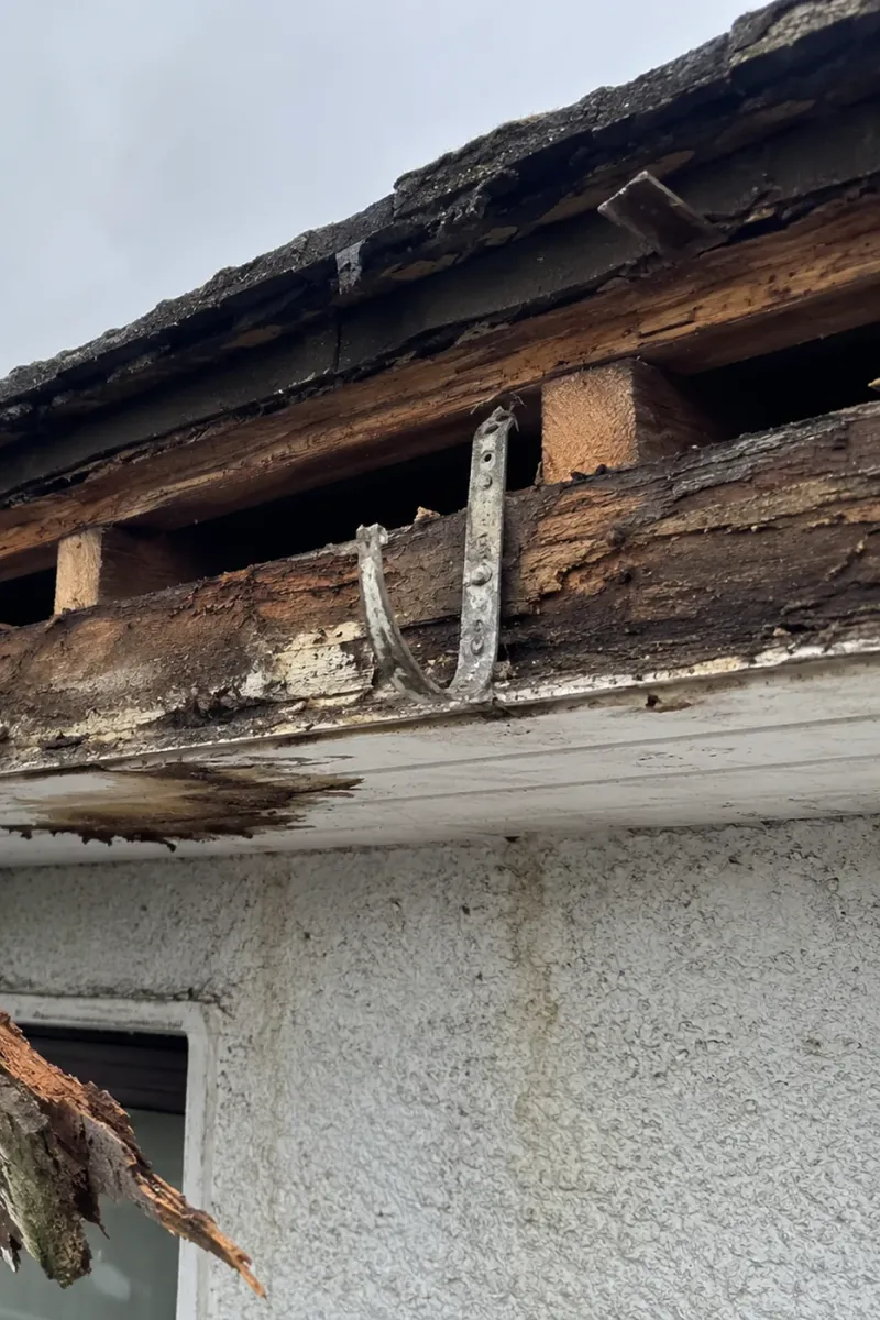 Rotten timber fascia being stripped off a Dublin home