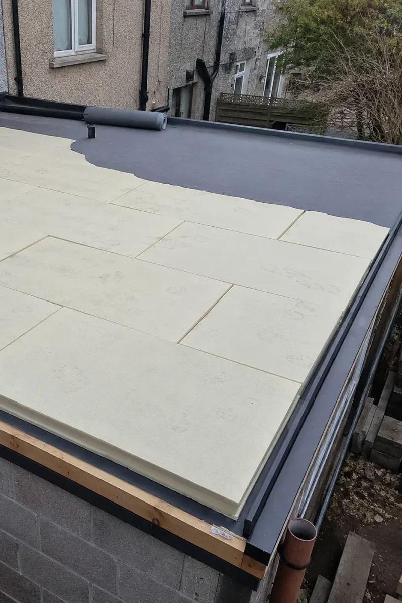 Insulation boards laid on a flat roof deck before the new covering