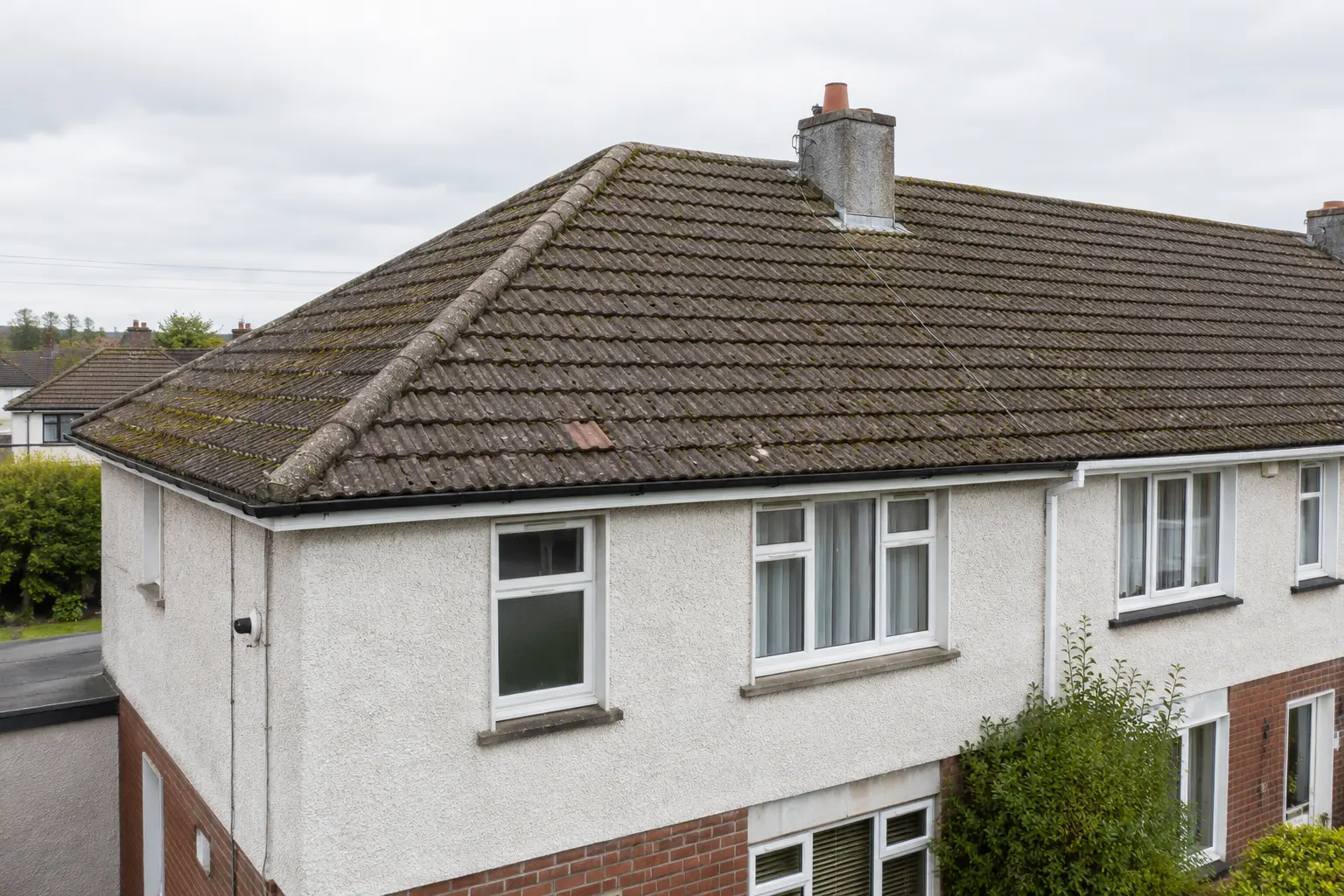 A worn tiled roof on a Dublin semi before re-roofing