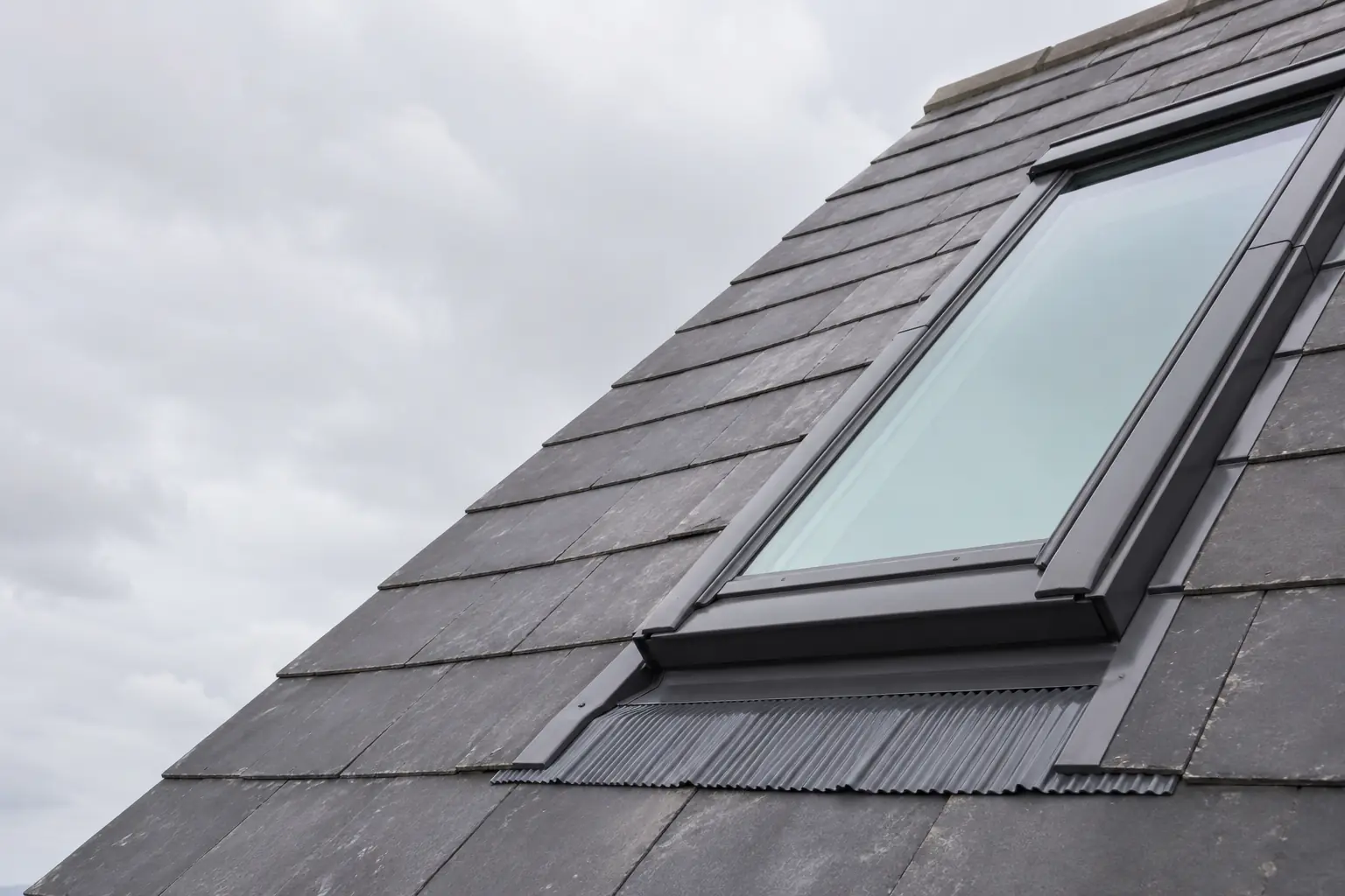 A Velux skylight set into a slate roof in Dublin, showing the flashing detail