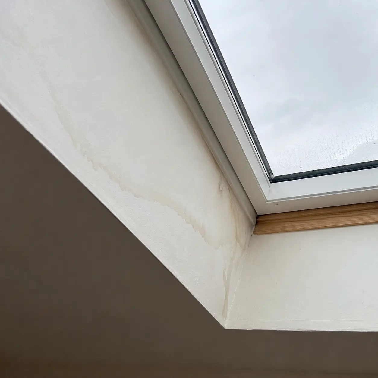 A water stain from a leaking skylight on a ceiling