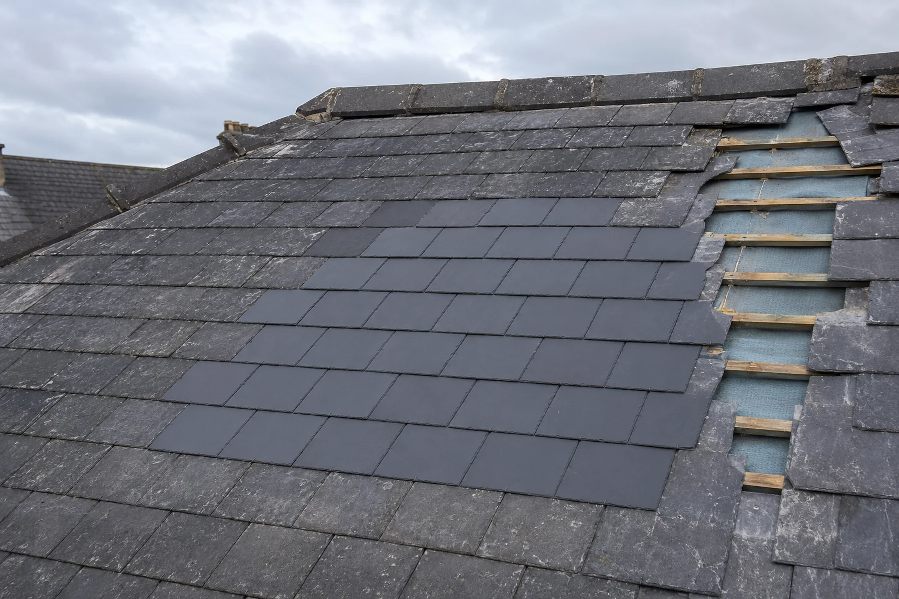 A new slate patch blended into an existing Dublin slate roof